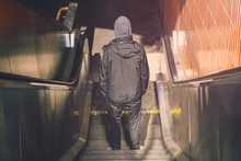 Berlin Underground, Back View Of A Young Man On An Escalator
