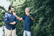 © chokniti - Hipster son with his senior father at home.