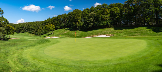 View of Golf Course with beautiful putting green. Golf course with a rich green turf beautiful scenery.	