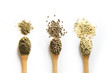 Organic dried hemp seeds, flour, kernels in wooden spoon on white background. View from above.