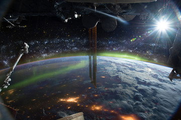 Wall Mural - international space station on orbit of earth planet. iss. stars and galaxies, city lights and auror