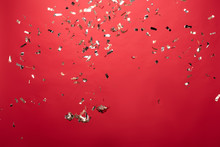 View Of Golden Christmas Confetti Isolated On Red