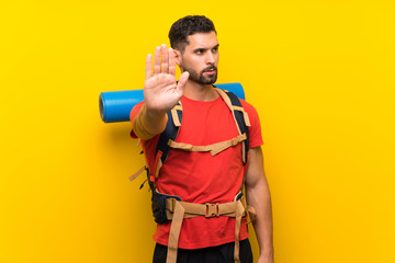 Young hiker man making stop gesture with her hand