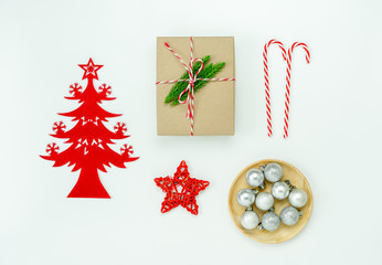 Wall Mural - Table top view of Merry Christmas decorations & Happy new year ornaments concept.Flat lay essential difference objects gift box & fir tree on modern white paper background at home studio office desk.