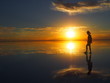 © Mithrax - Groom backlit by a beautiful sunset, the groom is standing on a salt lake with the landscape reflected, Salar de Uyuni, Salar de Uyuni is the world's largest salt flat, Bolivia
