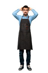 Wall Mural - Full-length shot of Man with apron frustrated and takes hands on head over isolated white background
