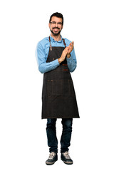 Wall Mural - Full-length shot of Man with apron applauding after presentation in a conference over isolated white background