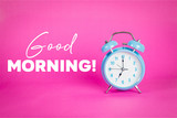 Fototapeta Mapy - Retro blue pastel alarm clock on a pink background with quote Good morning