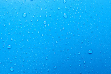 water drops on light blue background, top view
