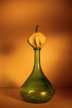 Isolated Yellow Pumpkin On Green Bottle