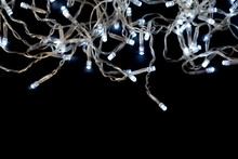 Christmas Garland With Lights On A Black Background.