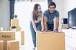 © successphoto - Happy young couple is having fun with cardboard box at new home.Moving house.