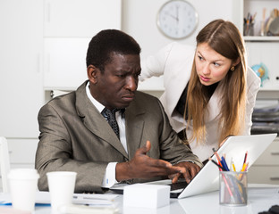 Focused coworkers working together