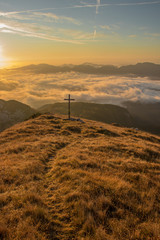 Mountain sunrise with big cross