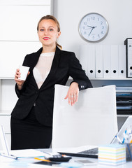 Cheerful woman in suit working in the modern office