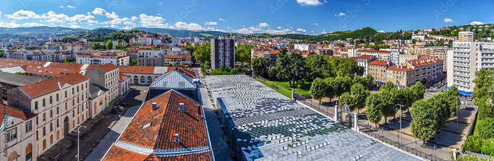 Panoramic view of Saint Etienne cityscape as seen from the tower of Cite du Design in downtown direction. Buildings of Higher School of Art and Design are at foreground. The Montaud hill is at right. - obrazy, fototapety, plakaty 