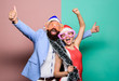 © be free - Happy man and woman wear santa hats and funny sunglasses. Christmas party office. Manager tinsel celebrate new year. Corporate holiday party ideas. Winter corporate party. Office christmas party