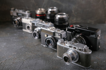 Old antique film cameras against a dark background.