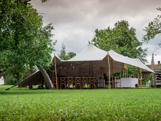 Image of huge white tent for a wedding event in the nature