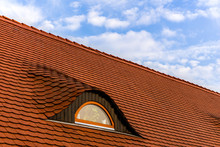 Red Tile Roof With Window And Blue Sky