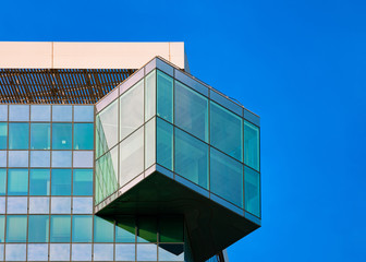 Wall Mural - Glass Abstract Business office building architecture in Modern City in Vienna of Austria. Urban corporate skyscraper exterior and skyline. Blue windows design