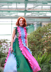 Wall Mural - beautiful red-haired girl in arranger where azalea blooms in a colorful flying dress