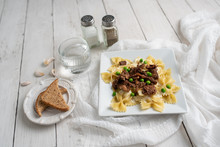 Beef Tips Over Bow Tie Pasta And Alfredo Sauce