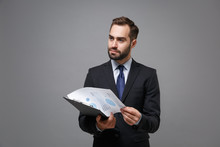 Pensive Young Business Man In Suit Shirt Tie Posing Isolated On Grey Background. Achievement Career Wealth Business Concept. Mock Up Copy Space. Hold Clipboard With Papers Document, Looking Aside.