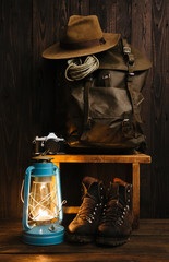 Wall Mural - vintage nomad's gear arranged on old wooden bench inside of remote cabin