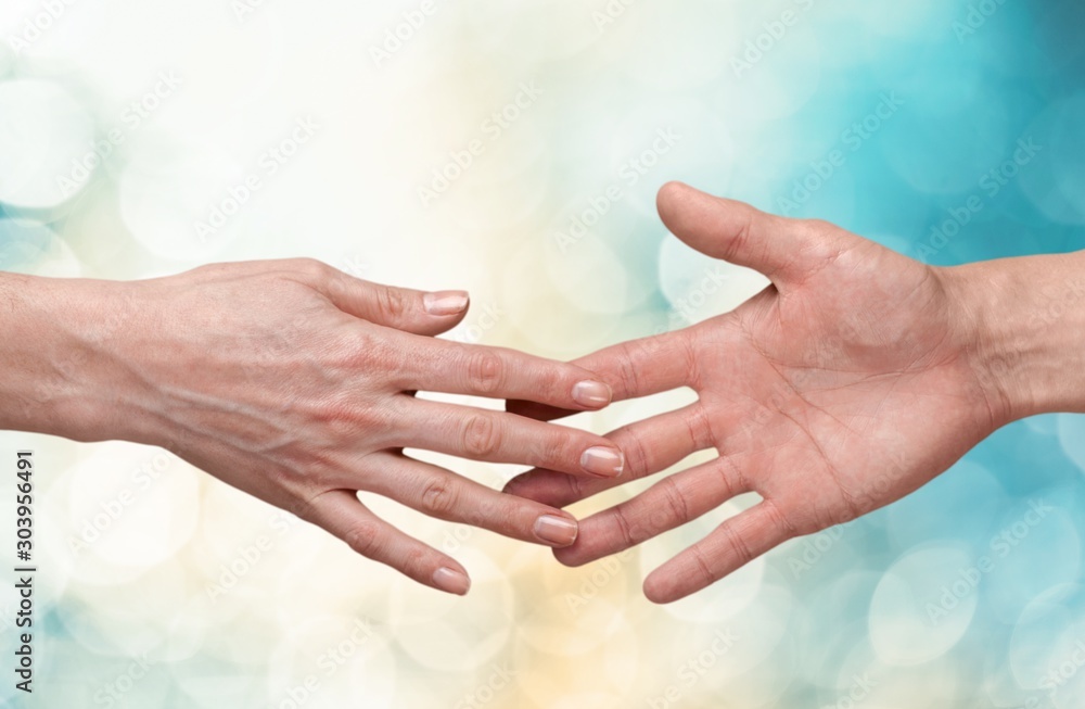 Female and male hands holding each other on background - obrazy, fototapety, plakaty 