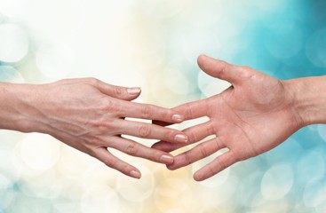 Wall Mural - Female and male hands holding each other on background