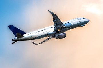 Airplane with two turbofan, fanjet engines and  winglets on cloud background, close-up