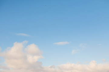 White fluffy clouds on a blue sky.