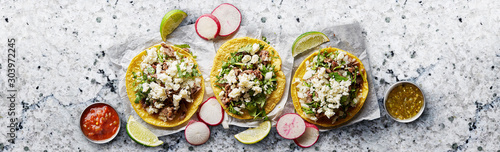 Fotomural three mexican street tacos with barbacoa and queso fresco cheese in flat lay com