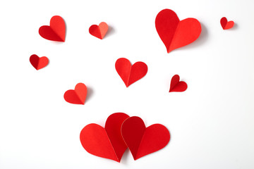 Red paper hearts on white background