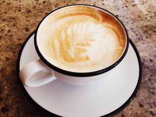 Cappuccino for breakfast in cafeteria, coffee cup on table in parisian cafe