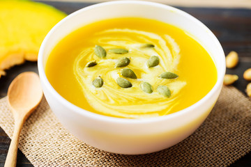 Canvas Print - Pumpkin soup with pumpkin seed and cream in a bowl