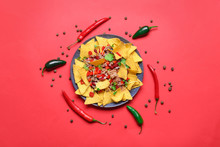 Plate With Tasty Chili Con Carne And Nachos On Color Background