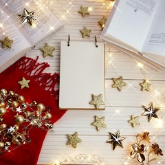 Sticker - Christmas to-do list.Winter layout. Winter holidays mockup. Empty notebook with  red knitted scarf and books, gold stars and shining garlands on a white wooden background.copy space.Winter holidays