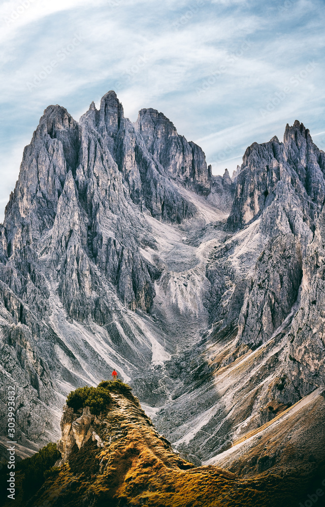Minimalistic mountains landscape with man against huge peaks - obrazy, fototapety, plakaty 