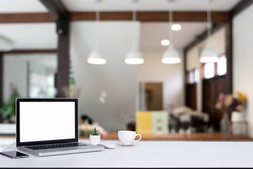 Computer notebook and mouse with a coffee shop behind the scenes Blur coffee shop