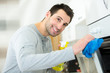 © auremar - janitor cleaning oven in kitchen