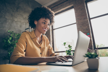 Photo of cheerful positive business lady smiling toothily looking into screen of notebook computer comparing corporate income for previous year with current one