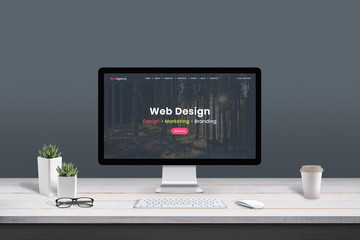 Fototapete - Web design studio concept. Work desk with computer display and modern design web agency page.