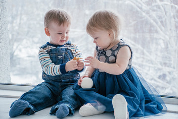 brother treats sister with cookies