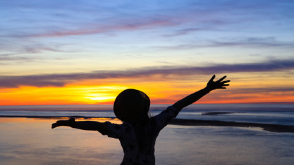 Happy moment in the Evening of woman Freedom , relax and happiness on the beach which enjoy of nature during travel summer in holidays ,Freedom vacation concept