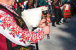 A man in a traditional Bulgarian costume plays an ancient musical folk wind instrument - bagpipes in Plovdiv, Bulgaria.