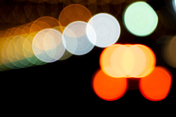 Defocused of photo bokeh blurred circle light from colorful neon lighting bulb in the night for abstract background texture pattern