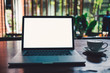 © jangnhut - A cup of cappuccino coffee with laptop white screen on table. Royalty high quality free stock photo image of coffee cup with laptop for working in a coffee shop, typing with blank screen white color