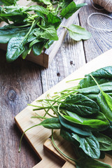 Wall Mural - Fresh organic spinach on wooden board